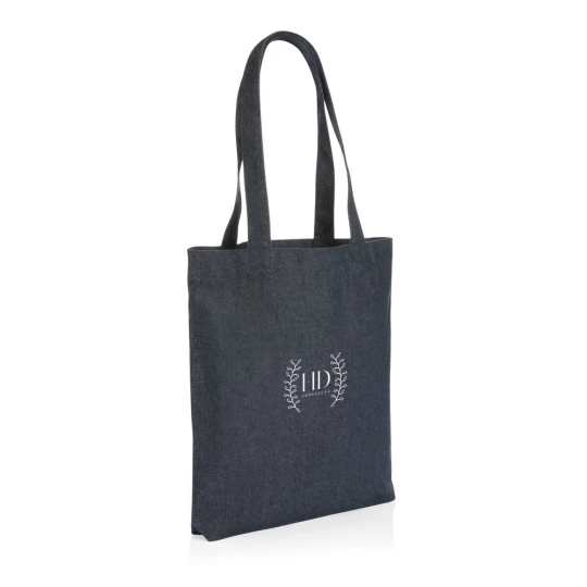 The Impact AWARE™ recycled denim tote 320gsm  is the perfect way to carry your essentials in style. This spacious tote provides sufficient space for your tech accessories and other daily needs. With AWARE™ tracer that validates the genuine use of rec-1
